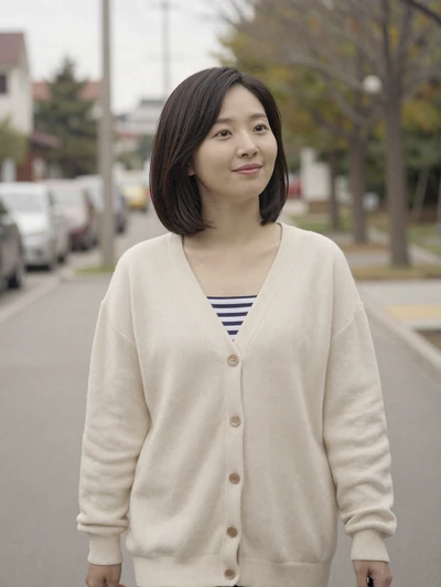 Hana walking along a quiet tree-lined sidewalk in a peaceful neighborhood